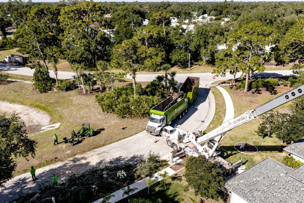 Aerial view of a grapple truck and crane on a tree removal haul-off in Sarasota