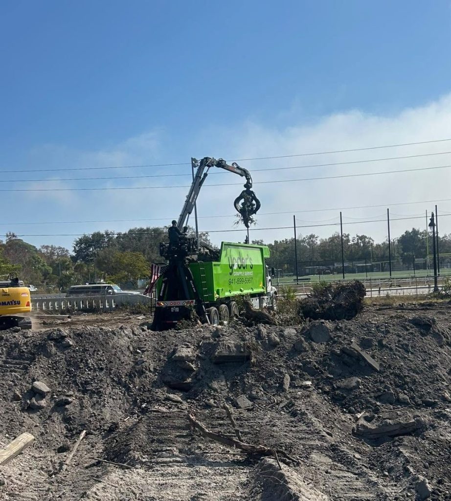 Grapple truck working a job site in Sarasota, Florida